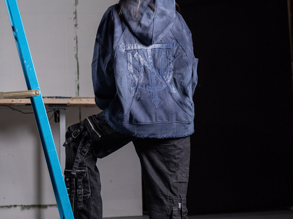 UNTAINED Never Cold hoodie worn by a model